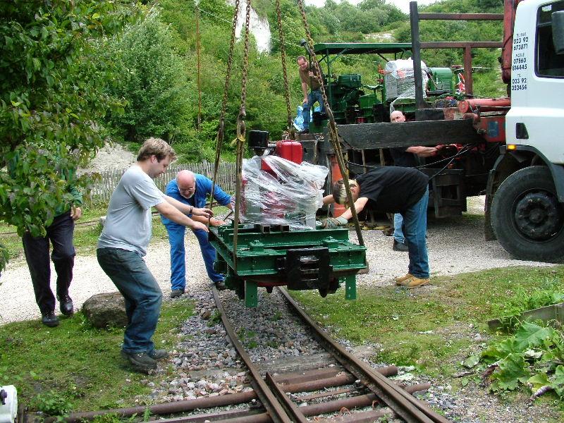 listerunload05.jpg - Jerry Oakey and Ian Hedgecock (nearer to the camera) steady things as the loco is lowered slowly.